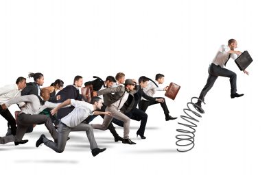 Overcome and achieve success Businessman jumping on a spring during a race with opponents